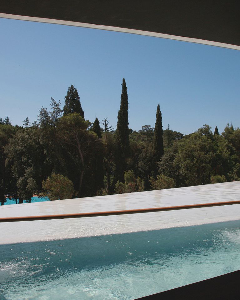 Infinity pool framed by dark architecture